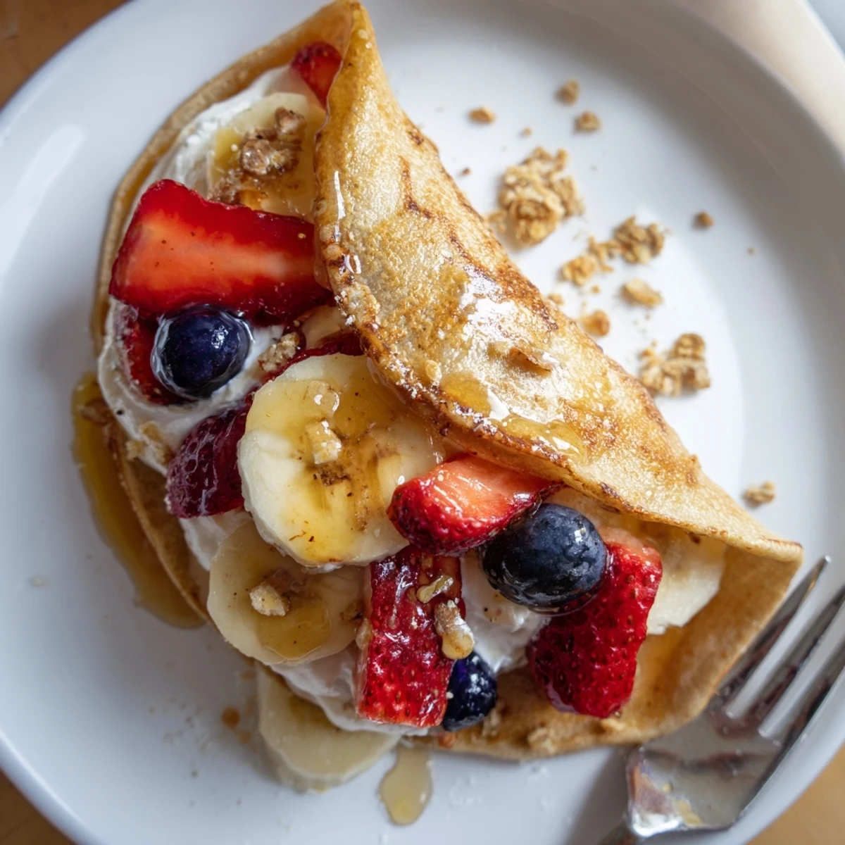 Soft pancake tacos loaded with blueberries, Greek yogurt, and granola for a fun breakfast