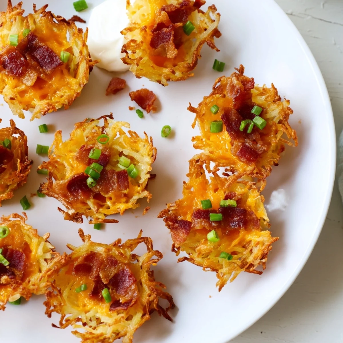 Warm cheesy loaded hashbrown bites fresh from the oven on a serving platter