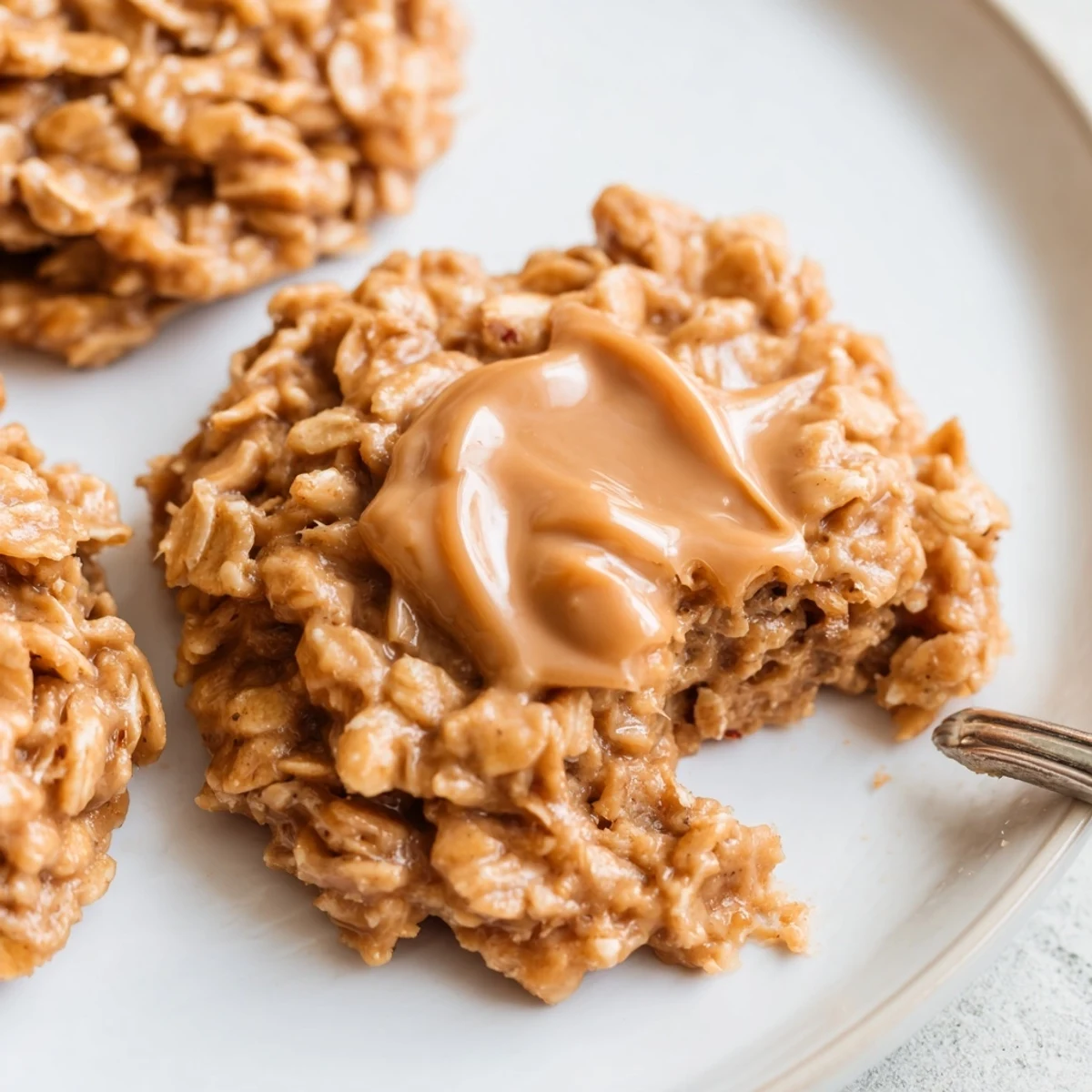 Rich chewy peanut butter no bake cookies with creamy oats on a plate.