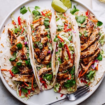 Golden seared chicken strips nestled atop crisp cabbage slaw inside these Thai chicken wraps